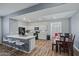 Open kitchen with white cabinets, gray walls, an island with barstool seating, and a wooden dining table at 12416 W Midway Ave, Glendale, AZ 85307
