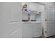 Modern laundry room featuring washer, dryer, and built-in shelving at 12416 W Midway Ave, Glendale, AZ 85307