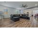Spacious living room with stylish wood floors and a large sectional couch at 12416 W Midway Ave, Glendale, AZ 85307