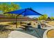 Shaded picnic area in a park setting with benches, a grill, and a trash receptacle, offering a great place to relax at 12416 W Midway Ave, Glendale, AZ 85307