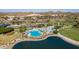 Aerial view of the community pool, splashpad, and lake surrounded by green spaces at 13446 S 186Th Ave, Goodyear, AZ 85338