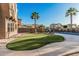Lush backyard with green grass, desert landscaping, palm trees, and pool at 13446 S 186Th Ave, Goodyear, AZ 85338