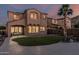 Expansive backyard featuring a well-manicured lawn, covered patio, and stucco exterior at 13446 S 186Th Ave, Goodyear, AZ 85338