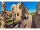 Spacious backyard with desert landscaping, pavers, air conditioning units, and a partial view of a covered patio at 13446 S 186Th Ave, Goodyear, AZ 85338