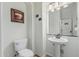 Neat half bath with pedestal sink, framed art, and white walls for a clean, updated feel at 13446 S 186Th Ave, Goodyear, AZ 85338