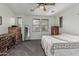 Sunlit bedroom with ceiling fan, carpet, window blinds, and wood furniture at 13446 S 186Th Ave, Goodyear, AZ 85338