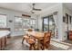 Bright dining area with a wooden table, large windows overlooking the backyard, and a sliding door at 13446 S 186Th Ave, Goodyear, AZ 85338