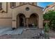 Charming stucco home featuring a covered front porch with column and desert landscaping at 13446 S 186Th Ave, Goodyear, AZ 85338