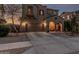 Elegant two-story home with a large driveway, arched entrance, and desert landscaping at 13446 S 186Th Ave, Goodyear, AZ 85338