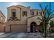Exterior view highlighting the home's desert landscaping, arched entry, and attached garage at 13446 S 186Th Ave, Goodyear, AZ 85338