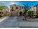 Home featuring an arched entry, two-car garage, and drought-tolerant desert landscaping at 13446 S 186Th Ave, Goodyear, AZ 85338
