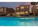Sunset view of backyard pool, patio, and desert landscaping of this two-story home at 13446 S 186Th Ave, Goodyear, AZ 85338