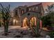 Charming exterior showcasing an arched entryway, desert landscaping, and a two-car garage at 13446 S 186Th Ave, Goodyear, AZ 85338