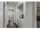 Bright hallway with gray carpet leading to a bedroom with a ceiling fan and an arched niche at 13446 S 186Th Ave, Goodyear, AZ 85338