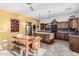 Bright kitchen with wooden cabinets, island, stainless steel appliances, and eat-in dining area at 13446 S 186Th Ave, Goodyear, AZ 85338