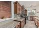 Stylish kitchen featuring wooden cabinets, granite countertops, and stainless-steel appliances at 13446 S 186Th Ave, Goodyear, AZ 85338