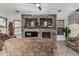 Comfortable living room with stone fireplace, tile floors, and neutral decor, perfect for relaxation at 13446 S 186Th Ave, Goodyear, AZ 85338