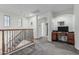 Bright upper landing with carpet, railing, natural light, and study nook at 13446 S 186Th Ave, Goodyear, AZ 85338