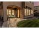 Covered patio with a ceiling fan and stylish outdoor furniture next to a well-manicured lawn at 13446 S 186Th Ave, Goodyear, AZ 85338