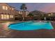 Backyard oasis featuring a sparkling pool, lush lawn, and mountain views at 13446 S 186Th Ave, Goodyear, AZ 85338