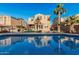 Backyard oasis featuring a sparkling pool, desert landscaping, and the reflection of the home against a clear sky at 13446 S 186Th Ave, Goodyear, AZ 85338