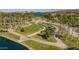 Aerial view of manicured walking paths meandering through lush landscaping with a scenic lake and mountain backdrop at 13446 S 186Th Ave, Goodyear, AZ 85338