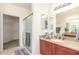 Bathroom featuring a granite vanity top, a walk-in shower, and a walk-in closet at 15252 N 100Th St # 1156, Scottsdale, AZ 85260