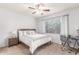 Bright bedroom with a ceiling fan, a large window, a desk, and neutral tones for a calming atmosphere at 15252 N 100Th St # 1156, Scottsdale, AZ 85260