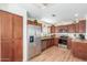 Modern kitchen with stainless steel appliances, granite countertops, and wood cabinets at 15252 N 100Th St # 1156, Scottsdale, AZ 85260