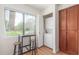 Functional laundry area featuring a stacked washer and dryer, wooden cabinets, and a window for natural light at 15252 N 100Th St # 1156, Scottsdale, AZ 85260
