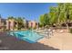 Community pool with a clear blue pool and lounging chairs at 15252 N 100Th St # 1156, Scottsdale, AZ 85260