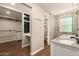 Well-lit bathroom featuring double sinks, granite countertops and open closet and toilet area for added convenience at 1527 E Sunnyslope Ln, Phoenix, AZ 85020