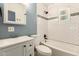 Bathroom featuring modern tilework, a stylish vanity, and ample natural light at 1527 E Sunnyslope Ln, Phoenix, AZ 85020