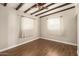 Bright bedroom featuring exposed beam ceiling, wood flooring and two large windows at 1527 E Sunnyslope Ln, Phoenix, AZ 85020
