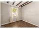 Bedroom featuring hardwood floors, exposed beam ceiling, and natural light at 1527 E Sunnyslope Ln, Phoenix, AZ 85020