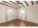 Bright bedroom featuring exposed beam ceiling, wood flooring and two large windows at 1527 E Sunnyslope Ln, Phoenix, AZ 85020