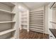 Large walk-in closet featuring custom shelving, hanging racks and lots of shoe storage at 1527 E Sunnyslope Ln, Phoenix, AZ 85020
