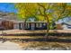 Charming home with landscaped yard, rock retaining wall, and a welcoming entrance, set against a desert mountain landscape at 1527 E Sunnyslope Ln, Phoenix, AZ 85020