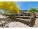 Charming home featuring attractive landscaping, a stone retaining wall, and a vibrant green tree against a mountain backdrop at 1527 E Sunnyslope Ln, Phoenix, AZ 85020