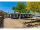 Well-maintained home with desert landscaping, gravel driveway, stone accents, and mature trees, creating an inviting curb appeal at 1527 E Sunnyslope Ln, Phoenix, AZ 85020
