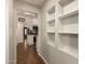 Interior view showcasing hallway with unique shelving leading into the kitchen area at 1527 E Sunnyslope Ln, Phoenix, AZ 85020