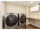Modern laundry room with stainless steel washer and dryer at 1527 E Sunnyslope Ln, Phoenix, AZ 85020