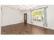 Bright living room with wood-look tile flooring, white brick wall and large window at 1527 E Sunnyslope Ln, Phoenix, AZ 85020