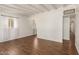 Spacious living room with hardwood floors, white brick walls, and ample natural light, perfect for relaxation and entertaining at 1527 E Sunnyslope Ln, Phoenix, AZ 85020
