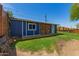 A blue and white shed sitting in a beautiful backyard with a wooden door and small white door at 1527 E Sunnyslope Ln, Phoenix, AZ 85020