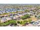 Expansive aerial view of a meticulously planned community featuring beige homes and green spaces against a mountain backdrop at 15704 W Taylor St, Goodyear, AZ 85338