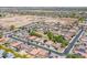 Aerial view of a community with diverse housing options, lush greenery, and developing land at 15704 W Taylor St, Goodyear, AZ 85338
