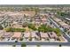 Aerial view of a sprawling neighborhood with mature trees and desert landscape in the background at 15704 W Taylor St, Goodyear, AZ 85338