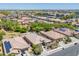 An aerial view of a neighborhood with well-maintained homes, tiled roofs and green trees at 15704 W Taylor St, Goodyear, AZ 85338