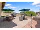 Relaxing backyard with a brick patio, outdoor furniture, and mountain views in the distance at 15704 W Taylor St, Goodyear, AZ 85338